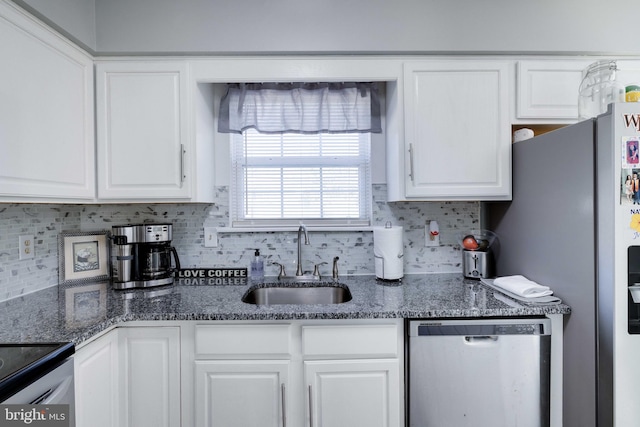 kitchen featuring white cabinetry, appliances with stainless steel finishes, sink, and backsplash