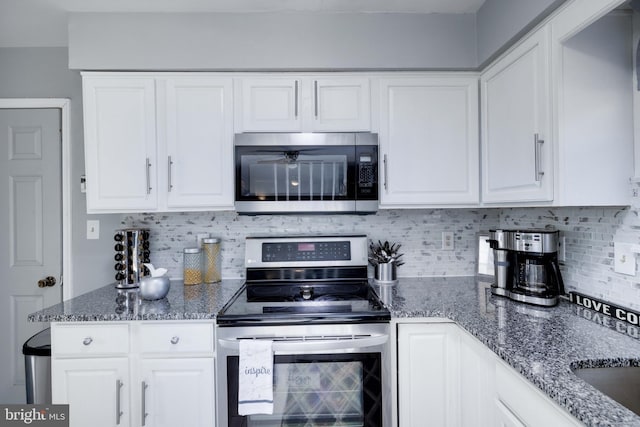 kitchen featuring tasteful backsplash, stainless steel appliances, and white cabinets