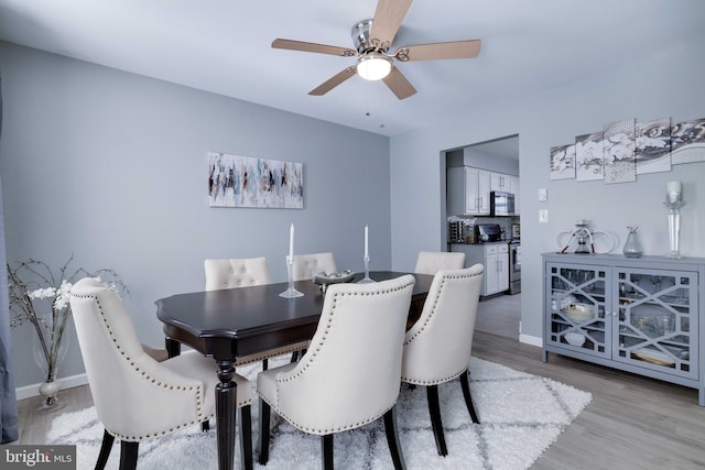 dining space featuring ceiling fan and light hardwood / wood-style floors