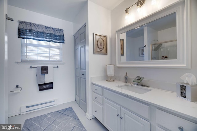 bathroom featuring vanity, a shower with door, and baseboard heating