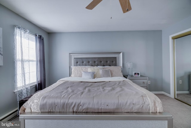 carpeted bedroom with ceiling fan, a baseboard radiator, and a closet