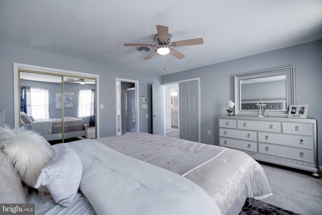 carpeted bedroom with ceiling fan and a closet