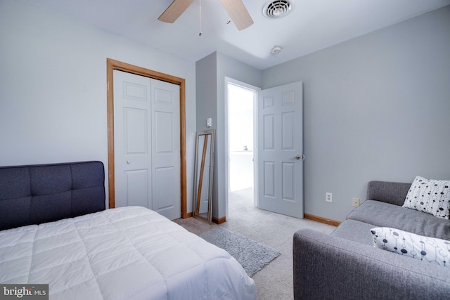 carpeted bedroom with ceiling fan and a closet