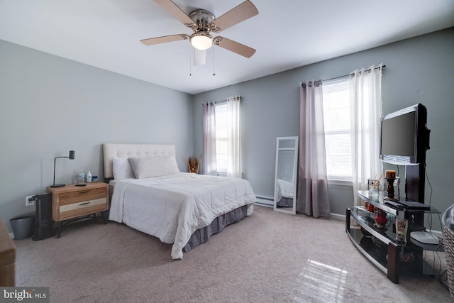 carpeted bedroom with baseboard heating and ceiling fan