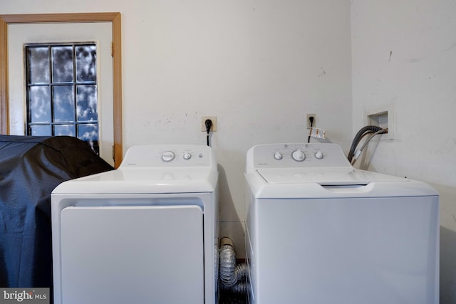 laundry area with washing machine and clothes dryer