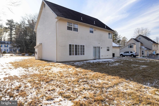 view of snow covered back of property