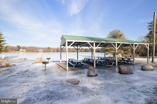 view of dock with a gazebo and a water view