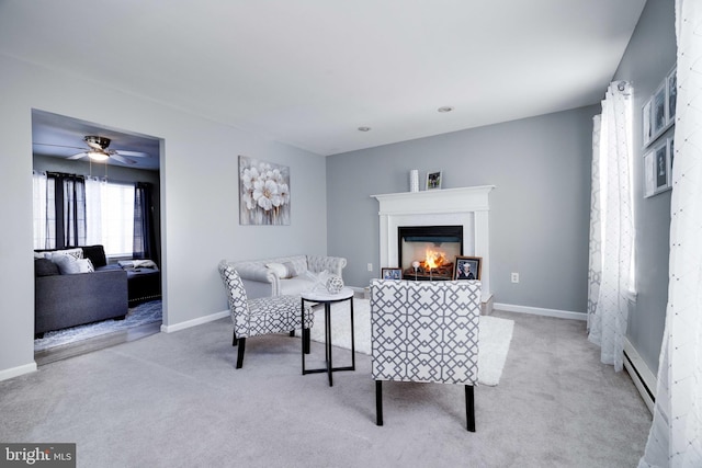 living room with a baseboard radiator and light carpet