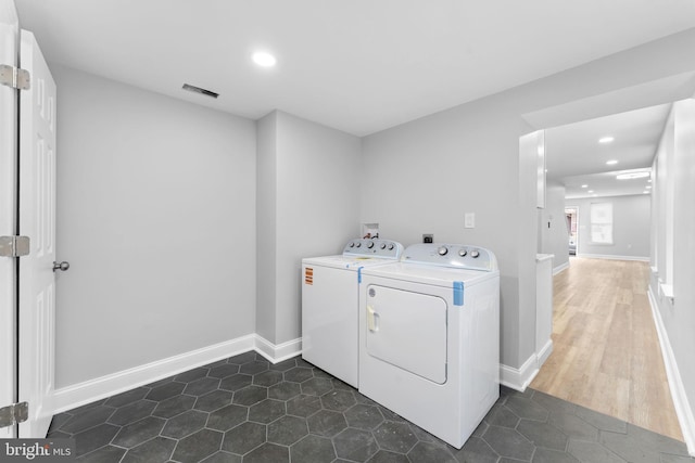 washroom with recessed lighting, laundry area, dark tile patterned floors, and baseboards