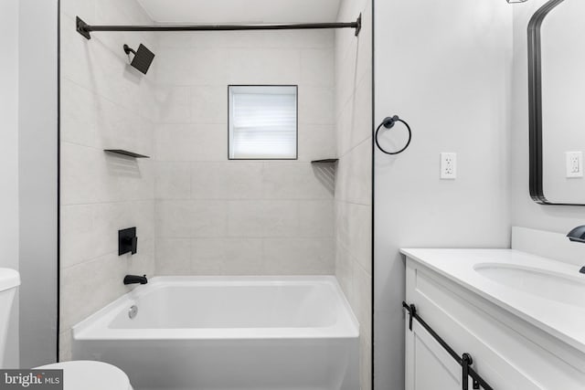 bathroom featuring shower / bathing tub combination, vanity, and toilet