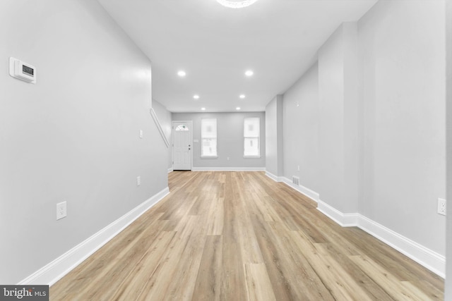 unfurnished living room with light wood-style flooring, visible vents, baseboards, and recessed lighting