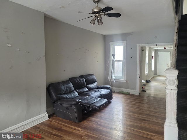 living room with dark hardwood / wood-style floors and ceiling fan