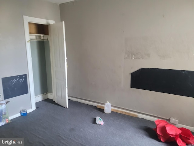 unfurnished bedroom featuring dark carpet