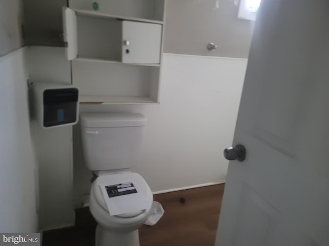 bathroom featuring hardwood / wood-style floors and toilet