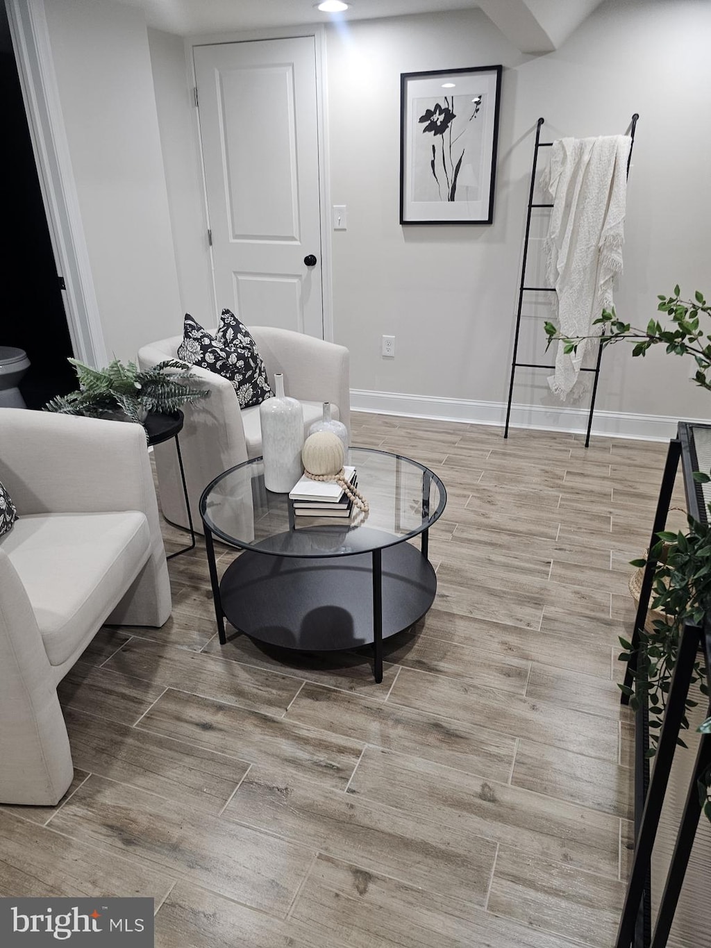 sitting room featuring wood finish floors and baseboards