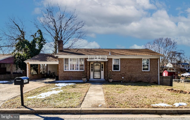 ranch-style house with a front yard and a carport