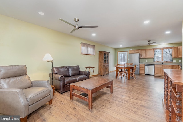 living room with recessed lighting, light wood-type flooring, and a ceiling fan