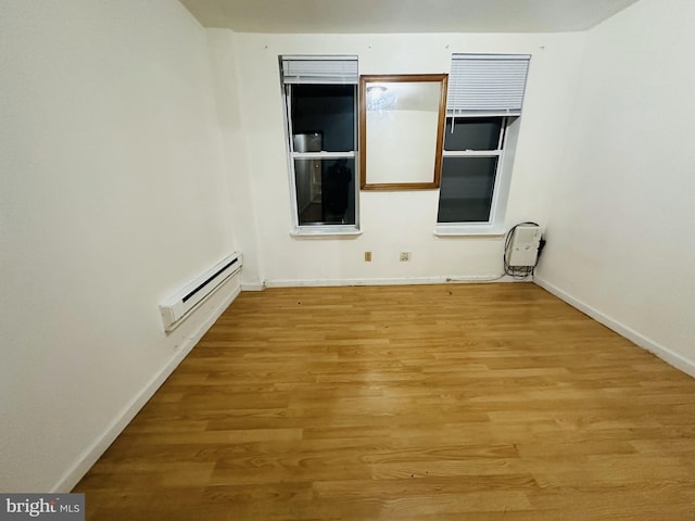 2018 S 7th St, Philadelphia, PA 19148 - unfurnished room featuring baseboard heating, baseboards, and light wood-style floors
