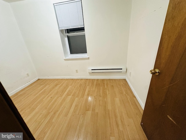 2018 S 7th St, Philadelphia, PA 19148 - spare room with baseboard heating, wood finished floors, and baseboards