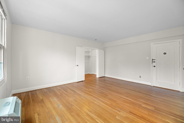 unfurnished living room with a wealth of natural light and light wood-type flooring