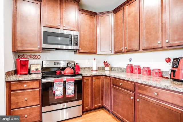 kitchen featuring stainless steel appliances and light wood-type flooring