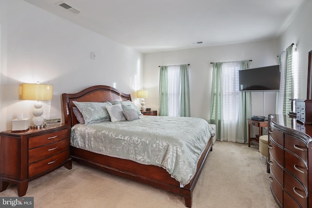 bedroom with light colored carpet