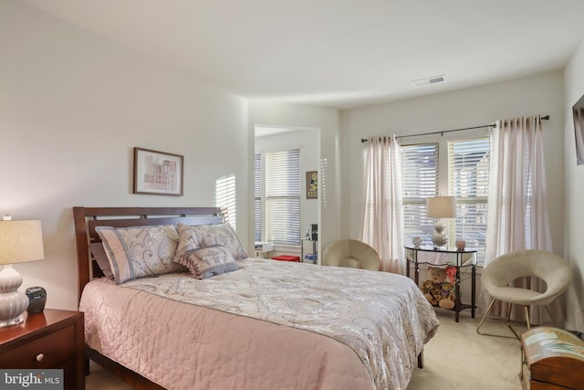 bedroom featuring light carpet