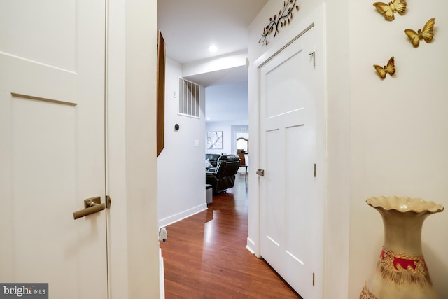 corridor with dark hardwood / wood-style floors