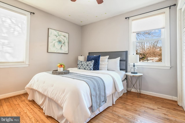 bedroom with baseboards and wood finished floors