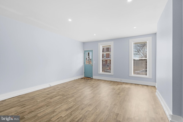 empty room with light hardwood / wood-style floors