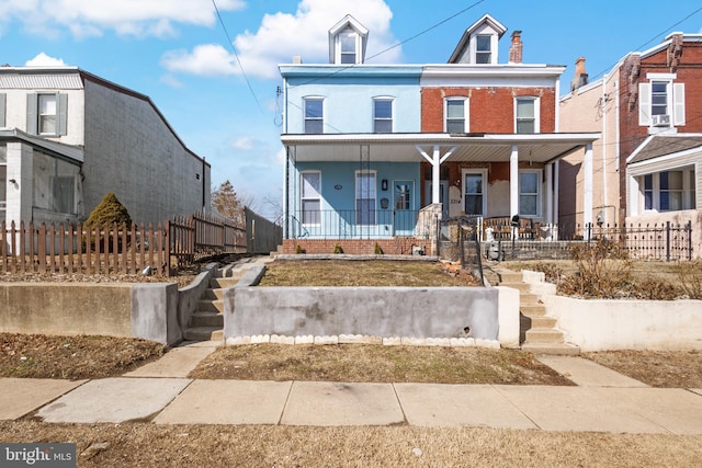 townhome / multi-family property featuring covered porch