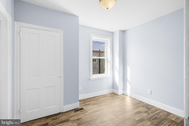 unfurnished bedroom featuring wood-type flooring