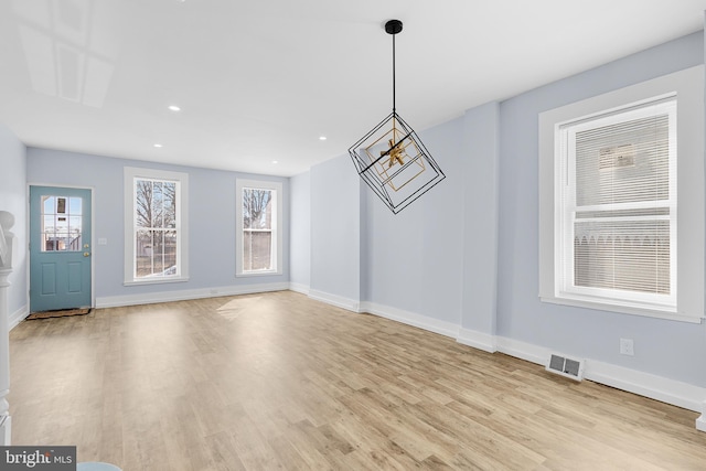 unfurnished dining area featuring light hardwood / wood-style floors