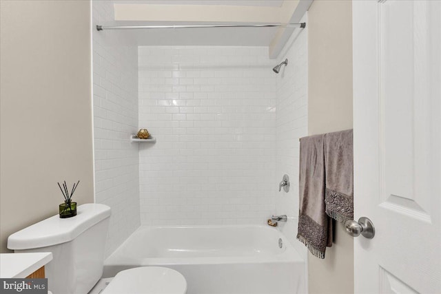 full bathroom with vanity, tiled shower / bath combo, and toilet