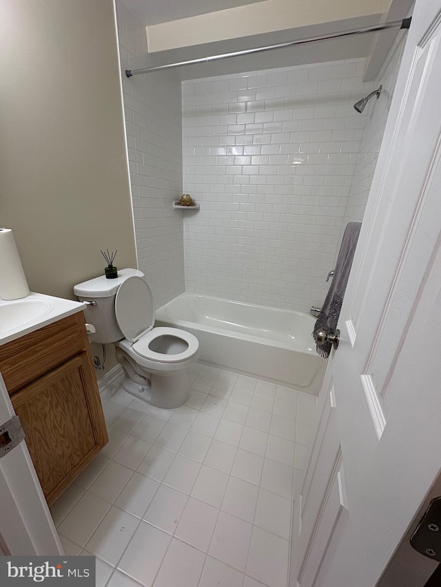 full bathroom with vanity, tiled shower / bath, tile patterned flooring, and toilet