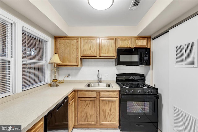 kitchen with sink, decorative backsplash, and black appliances