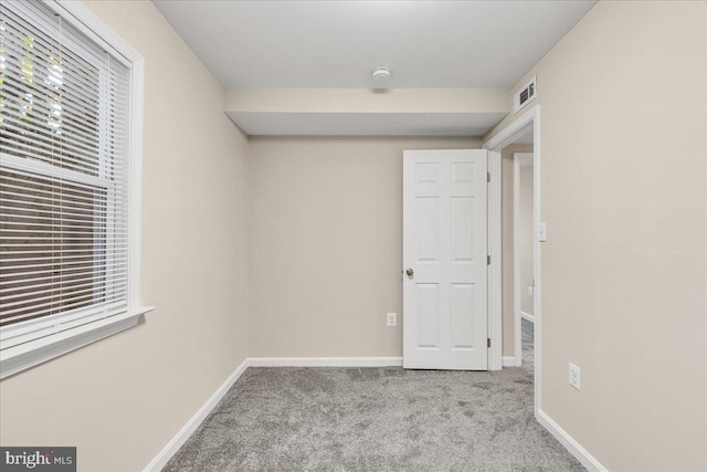 carpeted spare room with a wealth of natural light