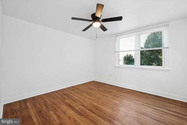 empty room featuring hardwood / wood-style flooring and ceiling fan