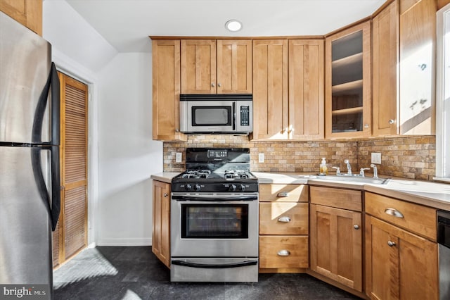 kitchen featuring tasteful backsplash, appliances with stainless steel finishes, and sink