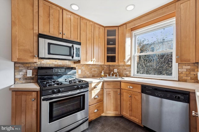 kitchen featuring sink, decorative backsplash, and appliances with stainless steel finishes