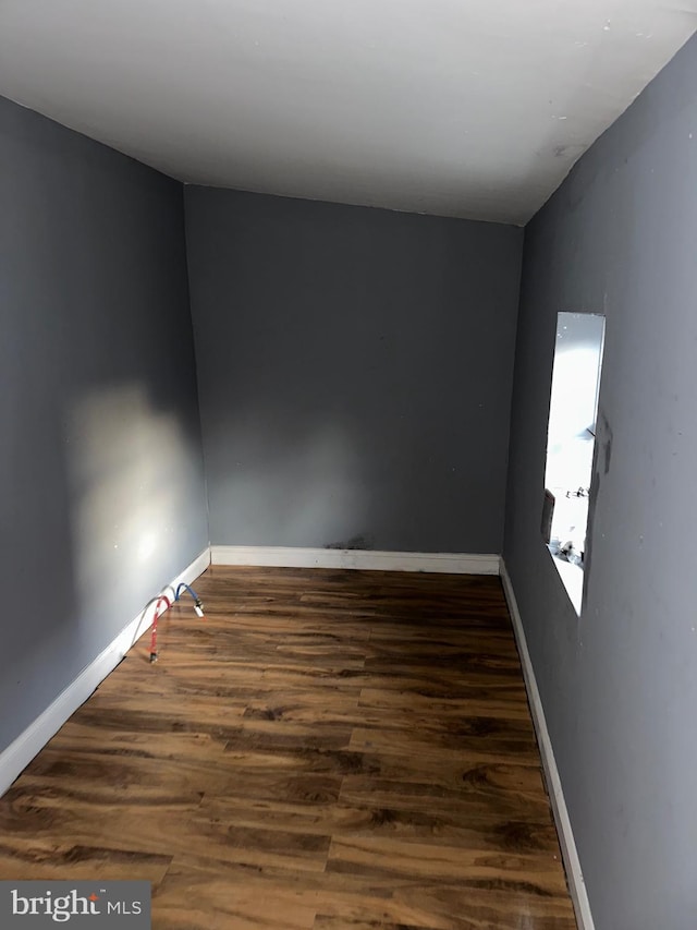 empty room with dark wood-type flooring