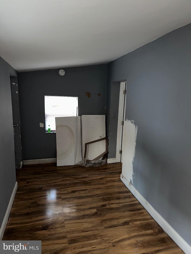 spare room featuring dark hardwood / wood-style flooring