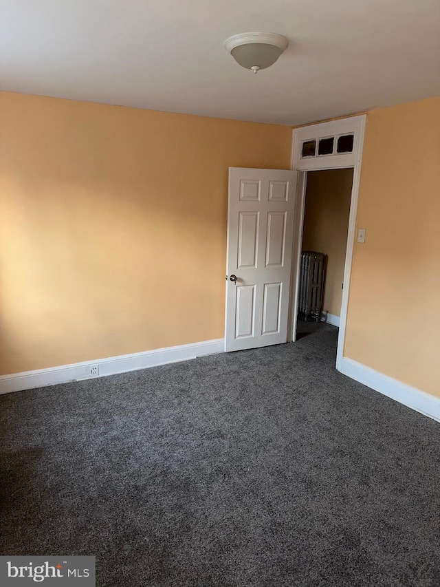 empty room with dark carpet