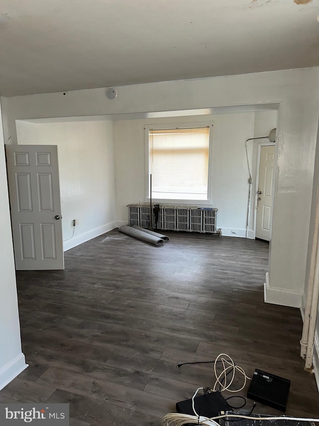 spare room with dark wood-type flooring