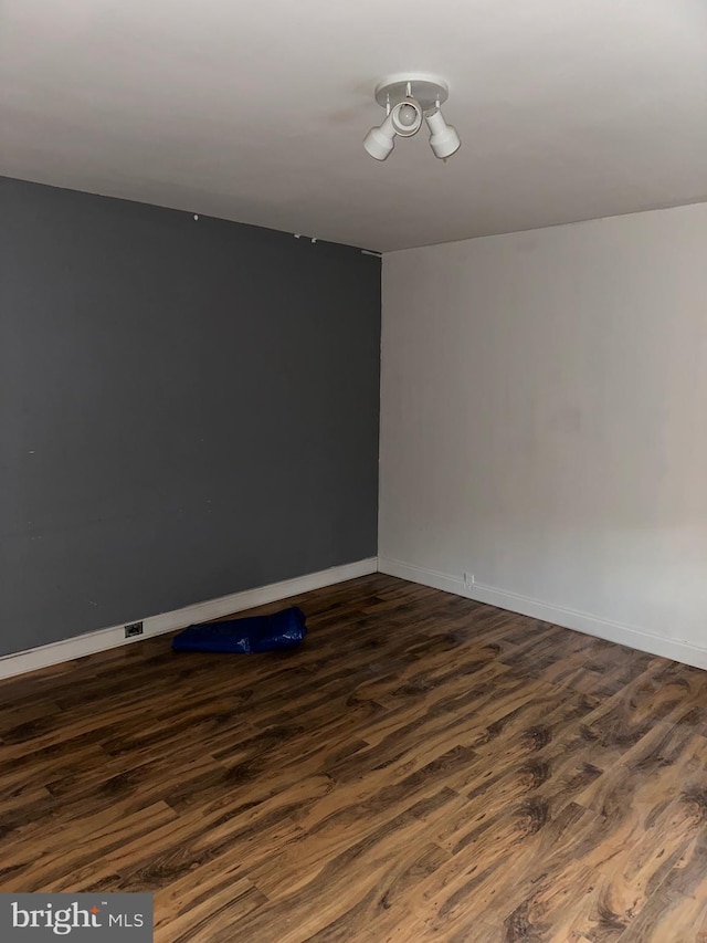 spare room with dark hardwood / wood-style flooring