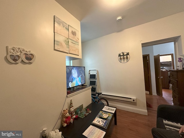 living room featuring dark wood-type flooring and baseboard heating