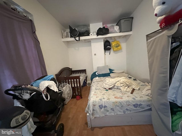 bedroom with dark wood-type flooring