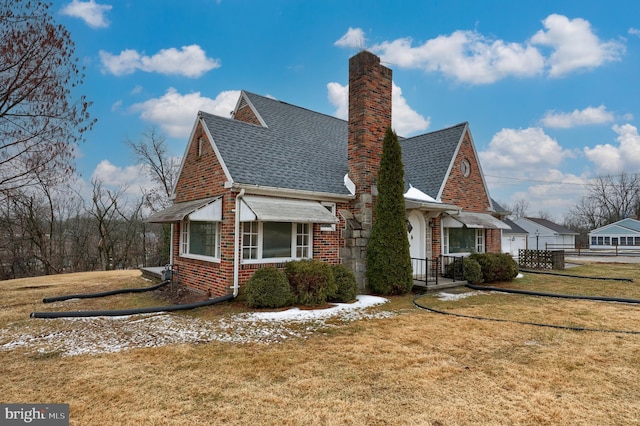 view of side of home with a yard