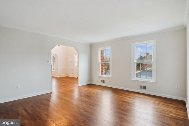 unfurnished room featuring dark wood-type flooring and ornamental molding