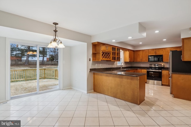 kitchen featuring light tile patterned flooring, sink, decorative light fixtures, appliances with stainless steel finishes, and kitchen peninsula